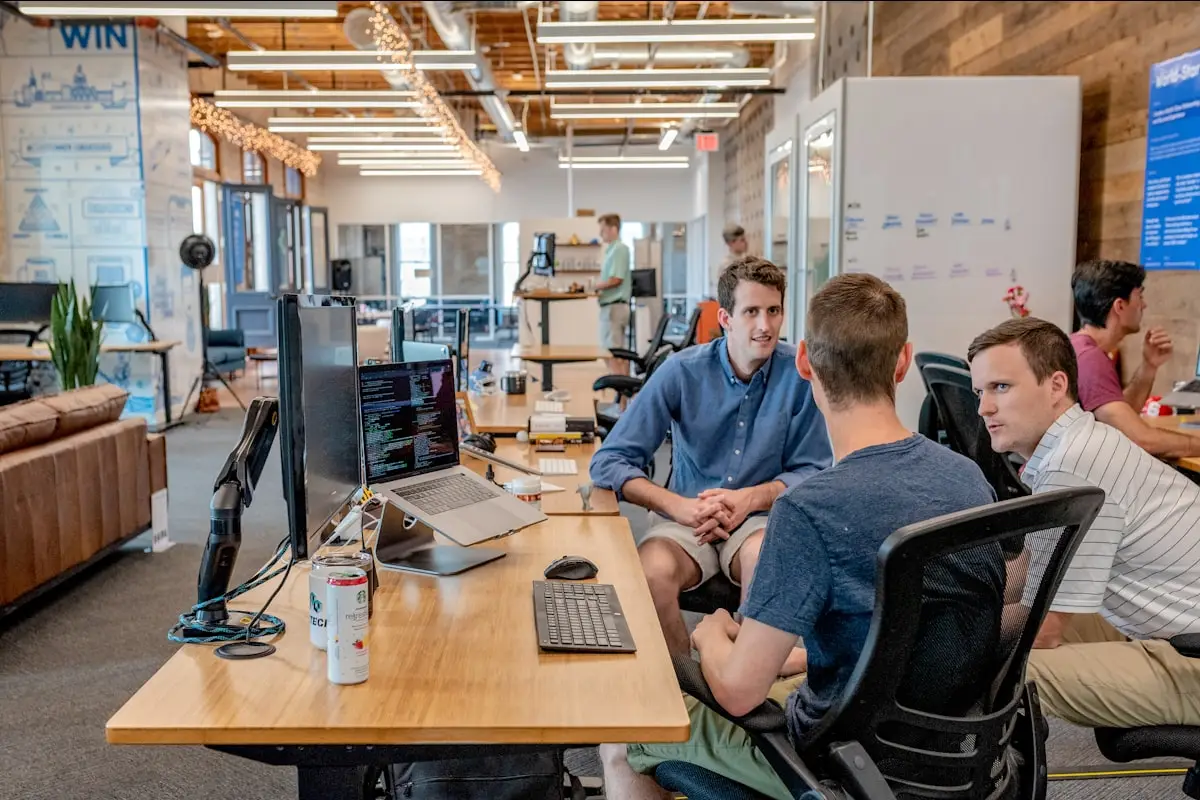 The team at work across a bank of screens in an open studio